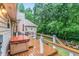Inviting backyard deck with a hot tub, outdoor seating, and lush green surroundings at 324 Kibbee Rd, Mcdonough, GA 30252