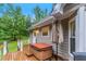 Relaxing backyard deck with a hot tub and easy access to the house and green surroundings at 324 Kibbee Rd, Mcdonough, GA 30252