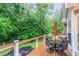 Charming backyard deck featuring outdoor dining set, lush greenery, and tranquil ambiance at 324 Kibbee Rd, Mcdonough, GA 30252