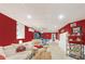 Finished basement with red walls and recessed lighting at 324 Kibbee Rd, Mcdonough, GA 30252