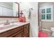 Cozy bathroom featuring a single sink vanity with a shower and tub combo at 324 Kibbee Rd, Mcdonough, GA 30252