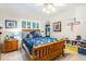 Charming bedroom with a wood frame bed, colorful decor, and a ceiling fan at 324 Kibbee Rd, Mcdonough, GA 30252