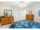 Bedroom features two dressers, a large closet, a wood frame bed, and a ceiling fan at 324 Kibbee Rd, Mcdonough, GA 30252