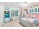 Bedroom with a large window, neutral walls, and a cozy bed with soft pink accents at 324 Kibbee Rd, Mcdonough, GA 30252