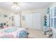 Comfortable bedroom with a closet, window, and neutral colored walls and flooring at 324 Kibbee Rd, Mcdonough, GA 30252