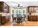 Sunlit breakfast nook showcases hardwood floors, custom cabinetry, and a cozy dining set at 324 Kibbee Rd, Mcdonough, GA 30252