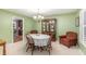 Dining room with green walls, a chandelier, and a dining table with seating at 324 Kibbee Rd, Mcdonough, GA 30252