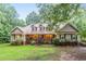 Charming ranch-style home features a welcoming front porch and well-maintained landscaping at 324 Kibbee Rd, Mcdonough, GA 30252