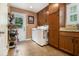Functional laundry room featuring built-in cabinets, sink, and a modern washer and dryer at 324 Kibbee Rd, Mcdonough, GA 30252