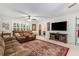 Comfortable living room featuring a large TV, ample seating, and a decorative area rug at 324 Kibbee Rd, Mcdonough, GA 30252