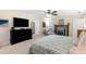 Large primary bedroom features neutral paint, a ceiling fan, fireplace, and plenty of space at 324 Kibbee Rd, Mcdonough, GA 30252