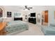 Spacious primary bedroom featuring a large bed, dressers, a TV, and access to the ensuite bathroom at 324 Kibbee Rd, Mcdonough, GA 30252