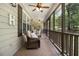 Comfortable screened porch showcasing a seating area, ceiling fan, and peaceful outdoor scenery at 324 Kibbee Rd, Mcdonough, GA 30252
