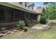 Exterior showcasing a side porch with lattice detail, brick edging, and pathway leading to the main structure at 324 Kibbee Rd, Mcdonough, GA 30252