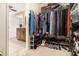 Organized walk-in closet with ample hanging space, shelving, and shoe storage at 324 Kibbee Rd, Mcdonough, GA 30252