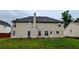 Back of house showing the siding and windows with a flat backyard at 4373 Abram Dr, Conley, GA 30288