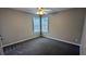 Cozy bedroom with plush carpet, a ceiling fan, and bright windows, perfect for relaxation at 4373 Abram Dr, Conley, GA 30288