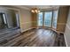 Dining room with large windows, chair rail, and new laminate wood flooring at 4373 Abram Dr, Conley, GA 30288