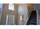 Grand foyer with high ceilings, staircase, and natural light from a large window at 4373 Abram Dr, Conley, GA 30288