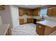 A bright kitchen with stainless steel appliances, wood cabinets, and attractive gray tile floors at 4373 Abram Dr, Conley, GA 30288