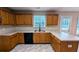 Well-lit kitchen with modern appliances, countertops, plenty of cabinet space, and grey tile floors at 4373 Abram Dr, Conley, GA 30288