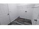 Efficient laundry room with wood-look flooring, storage shelves, and a utility sink hookup at 4373 Abram Dr, Conley, GA 30288