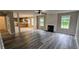 Open-concept living room with new flooring, fireplace, and view into the kitchen at 4373 Abram Dr, Conley, GA 30288