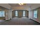Spacious main bedroom with vaulted ceiling, multiple windows, and plush carpet at 4373 Abram Dr, Conley, GA 30288