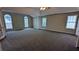 Expansive main bedroom boasting trey ceiling, plush carpet, with three large windows at 4373 Abram Dr, Conley, GA 30288