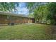 Spacious backyard with lush lawn and brick home exterior, perfect for outdoor activities and relaxation at 622 Sheffield Rd, Norcross, GA 30071