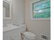 Clean bathroom featuring a vanity with sink, toilet, and a window with a pleasant outdoor view at 622 Sheffield Rd, Norcross, GA 30071