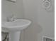 Close up shot of a sleek pedestal sink and towel holder in a bathroom at 622 Sheffield Rd, Norcross, GA 30071