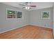 Bright bedroom with hardwood floors, ceiling fan, and a double window allowing for plentiful natural light at 622 Sheffield Rd, Norcross, GA 30071
