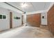 Garage space offering plenty of room for storage, a brick accent wall, and access to the outdoors at 622 Sheffield Rd, Norcross, GA 30071