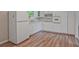 Well-lit kitchen features white cabinets, a refrigerator, and wood-look flooring for a modern touch at 622 Sheffield Rd, Norcross, GA 30071
