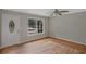 Bright living room features hardwood floors, a front door, and a large window providing natural light at 622 Sheffield Rd, Norcross, GA 30071