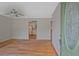 Inviting living room with hardwood floors and a view into the bright kitchen with a white refrigerator at 622 Sheffield Rd, Norcross, GA 30071