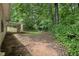 Spacious backyard featuring trees, shrubs, and a covered patio at 10073 Dorothy Ct, Jonesboro, GA 30236
