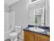 Bathroom showcasing a shower-tub combination and a vanity sink with dark countertop at 10073 Dorothy Ct, Jonesboro, GA 30236