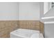 Close-up of bathtub with tile backsplash and chrome fixtures at 10073 Dorothy Ct, Jonesboro, GA 30236