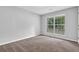 Bedroom with neutral walls, plush carpet, and natural light from a double window at 10073 Dorothy Ct, Jonesboro, GA 30236