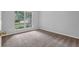 Bedroom showcasing a large window with exterior views and neutral carpet at 10073 Dorothy Ct, Jonesboro, GA 30236