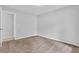 Bedroom featuring neutral walls, plush carpet, and a door to the bathroom at 10073 Dorothy Ct, Jonesboro, GA 30236