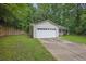 Side view of a single-story home featuring an attached two-car garage and concrete driveway at 10073 Dorothy Ct, Jonesboro, GA 30236