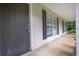 Home entry showcasing the front door and covered porch with black shutters at 10073 Dorothy Ct, Jonesboro, GA 30236