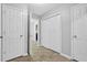 Hallway featuring multiple doors, a closet, and tile flooring at 10073 Dorothy Ct, Jonesboro, GA 30236