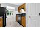 Traditional kitchen with wooden cabinets, black appliances, and ceramic tile flooring at 10073 Dorothy Ct, Jonesboro, GA 30236