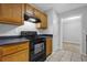 Modern kitchen with oak cabinets and black appliances at 10073 Dorothy Ct, Jonesboro, GA 30236