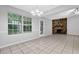 Bright living room with windows, fireplace, tile floor and contemporary lighting at 10073 Dorothy Ct, Jonesboro, GA 30236