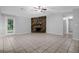 Spacious living room featuring a stone fireplace, tile floors, and a ceiling fan at 10073 Dorothy Ct, Jonesboro, GA 30236